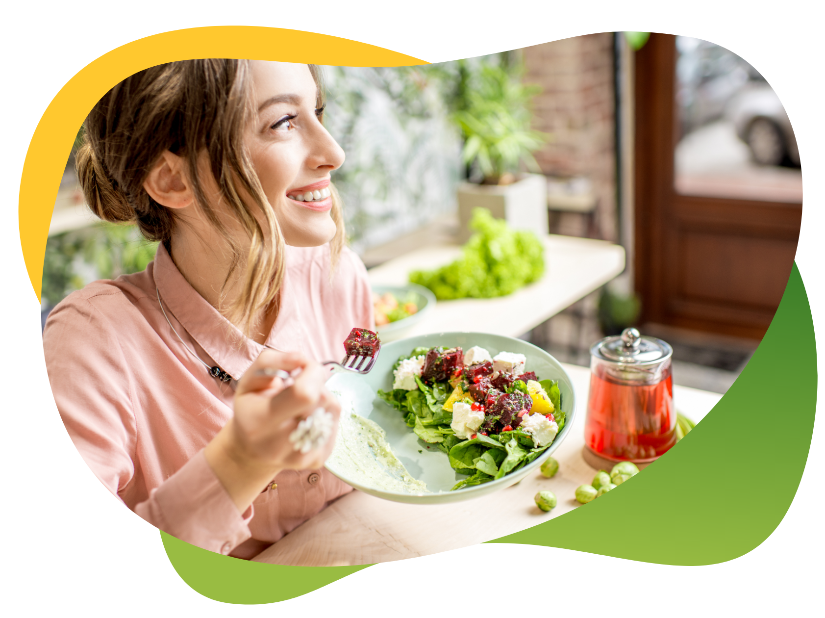 A young woman enjoying her salad and looking out the window